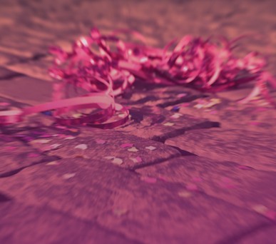 pink ribbon and confetti on brick ground